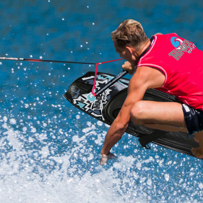 Person wakeboarding on a blue water surface